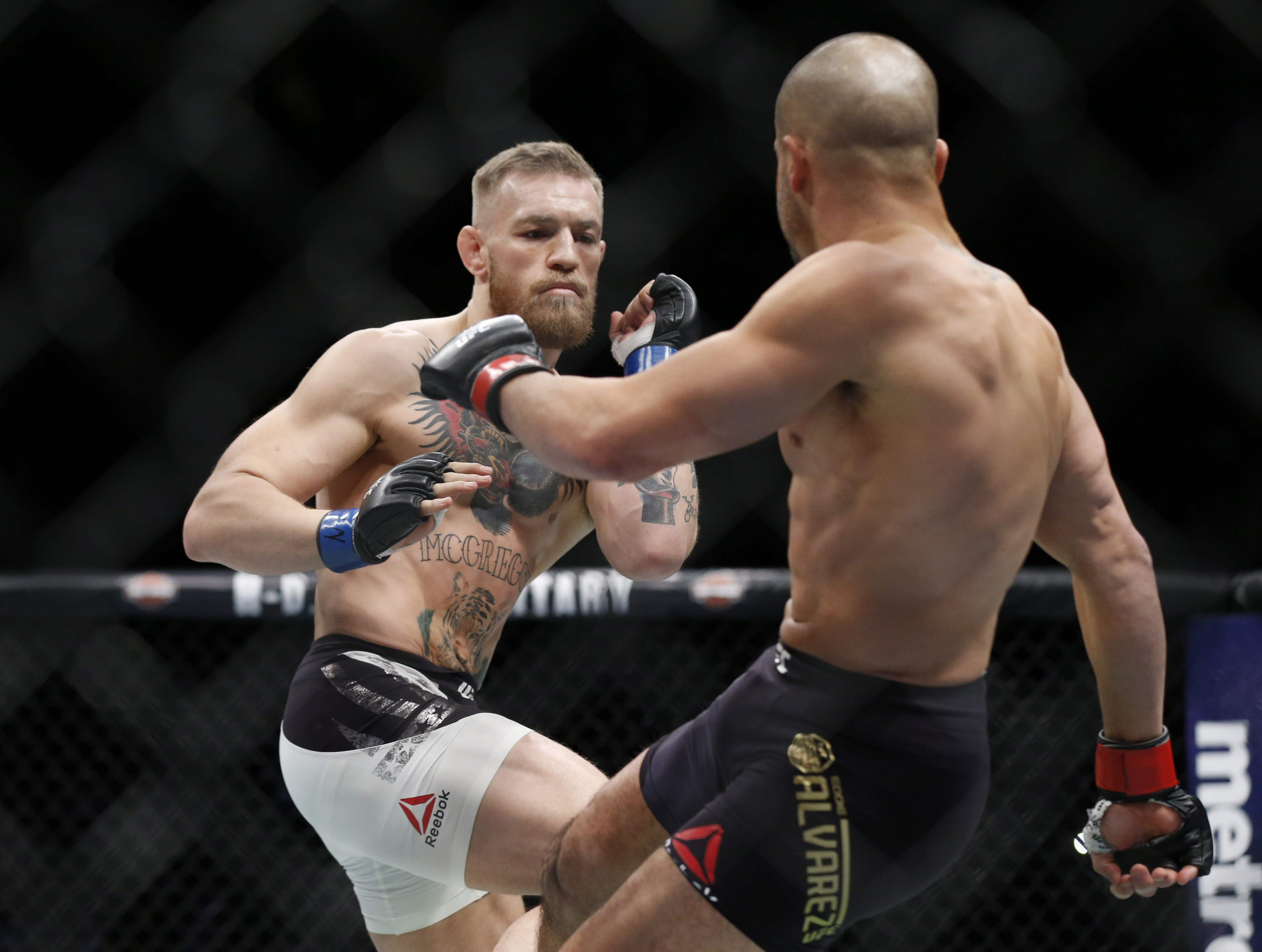 Nov 12, 2016; New York, NY, USA;  Conor McGregor (blue gloves) fights Eddie Alvarez (red gloves) in their lightweight title bout during UFC 205 at Madison Square Garden. Mandatory Credit: Adam Hunger-USA TODAY Sports